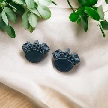 Black polymer clay earrings shaped like the Statue of Liberty crown, ready for wear