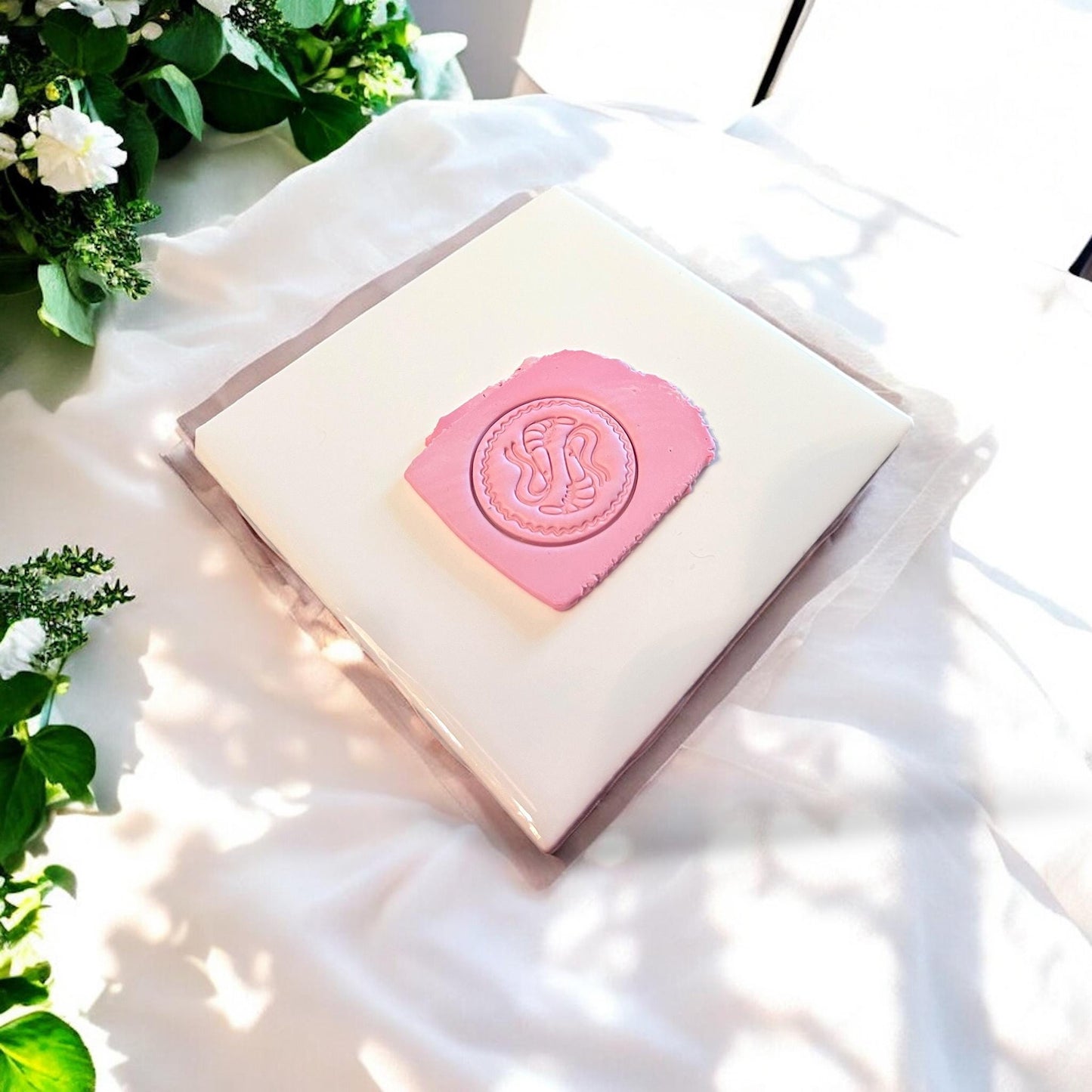 Playful shrimp-shaped polymer clay cutter pressed into blue clay slab, showcasing detailed design.
