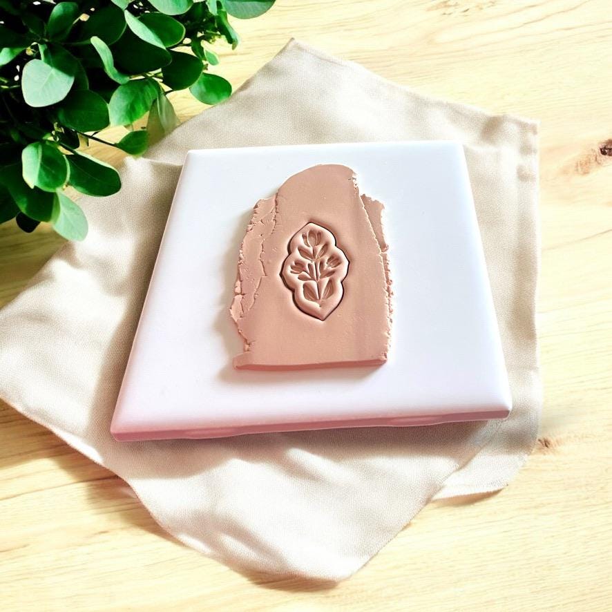 Pressed clay slab showing cutter impression with leaf-style design