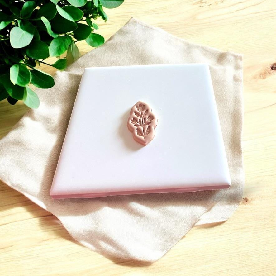 Pressed clay slab showing cutter impression with leaf-style design