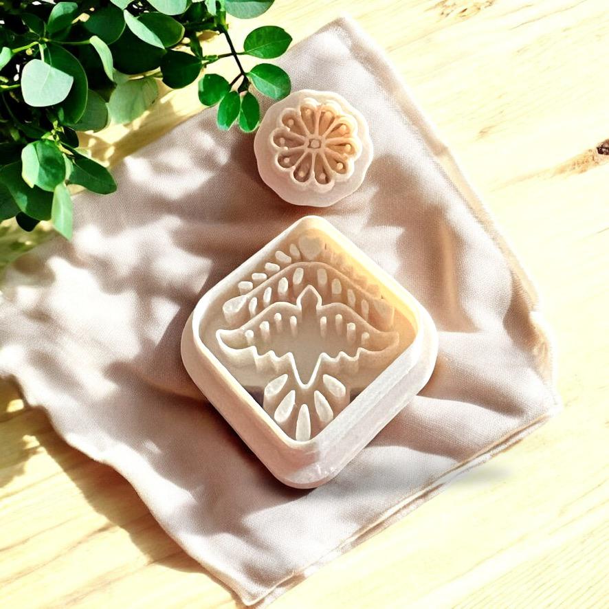 Artistic closeup of bird and flower cutters for polymer clay, showcasing boho, Aztec-inspired intricate detailing