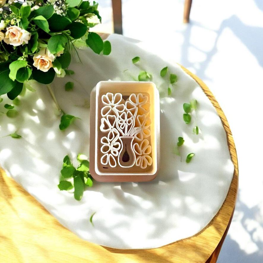 Close-up view of flower vase clay cutter showing bouquet details for jewelry making.