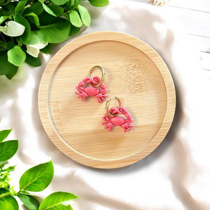Finished polymer clay crab earrings on bamboo dish