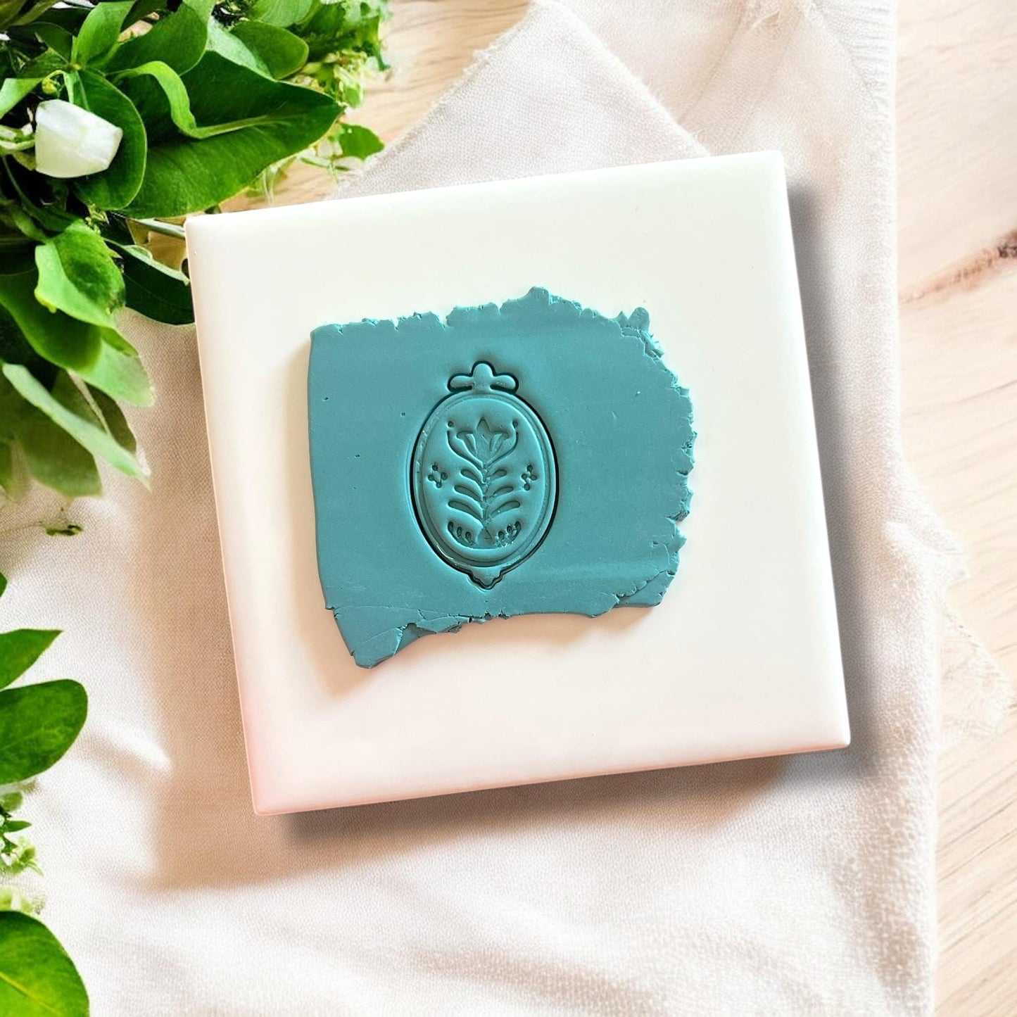Scandinavian floral impression in teal clay