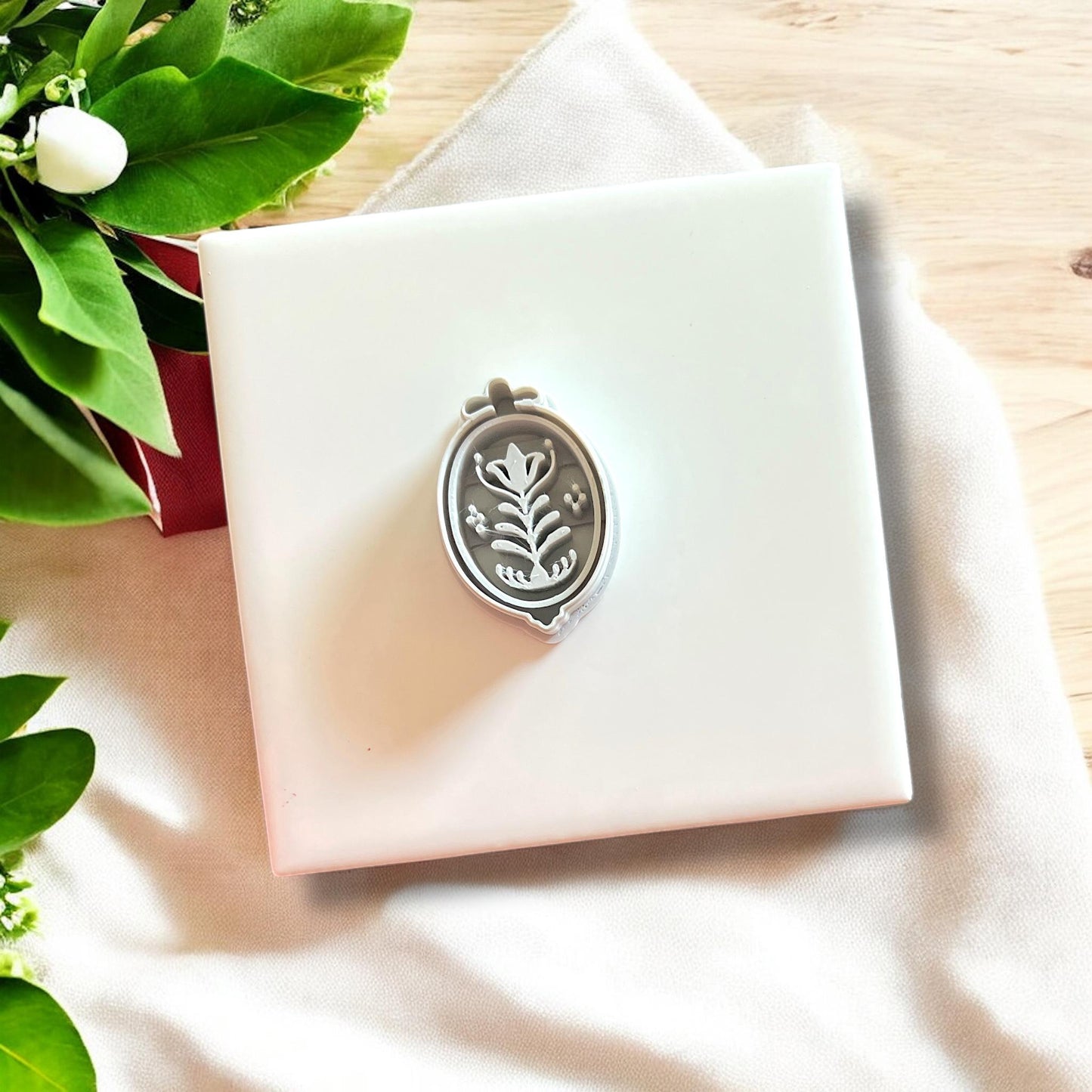 Framed floral polymer clay cutter on display