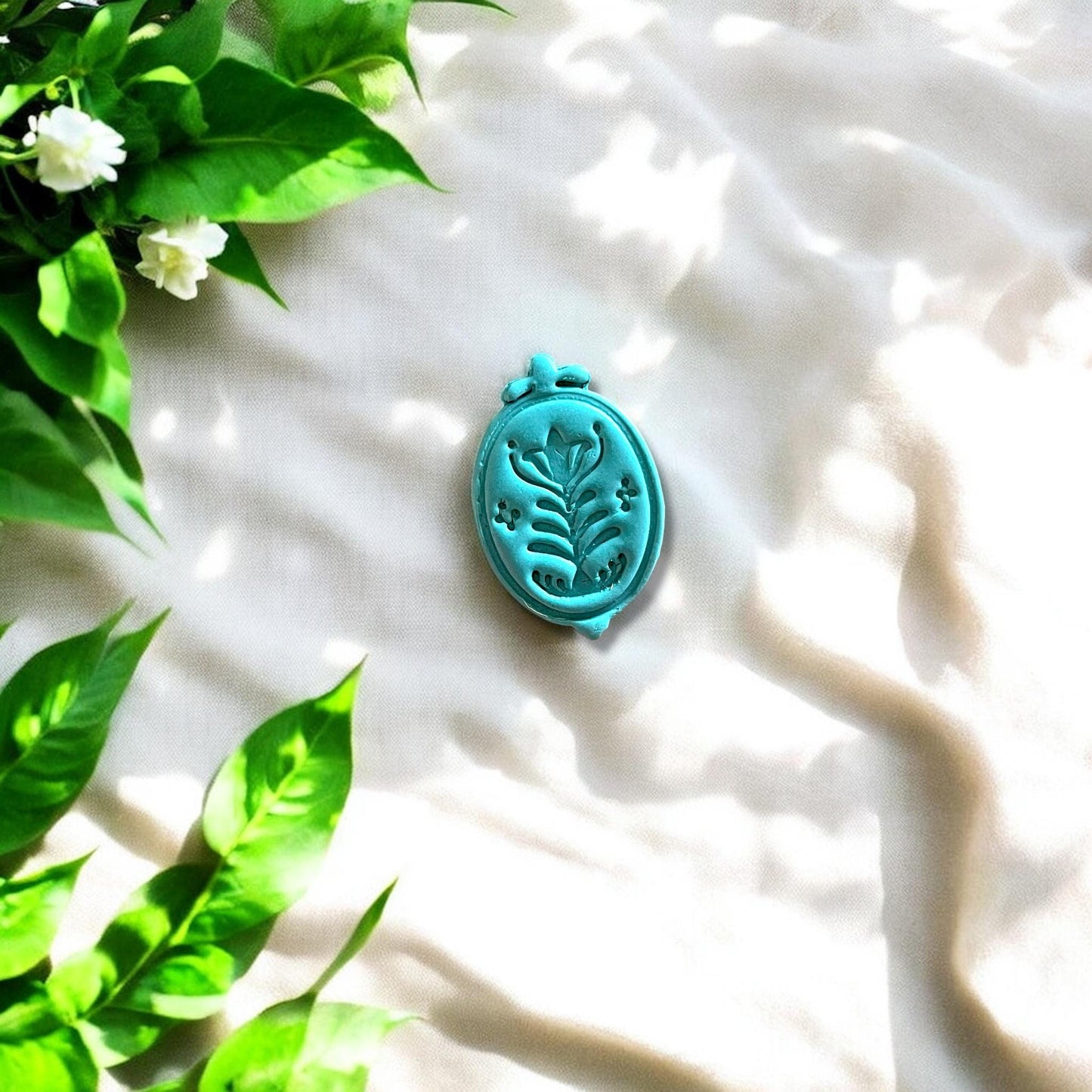 Detailed clay charm with boho floral design