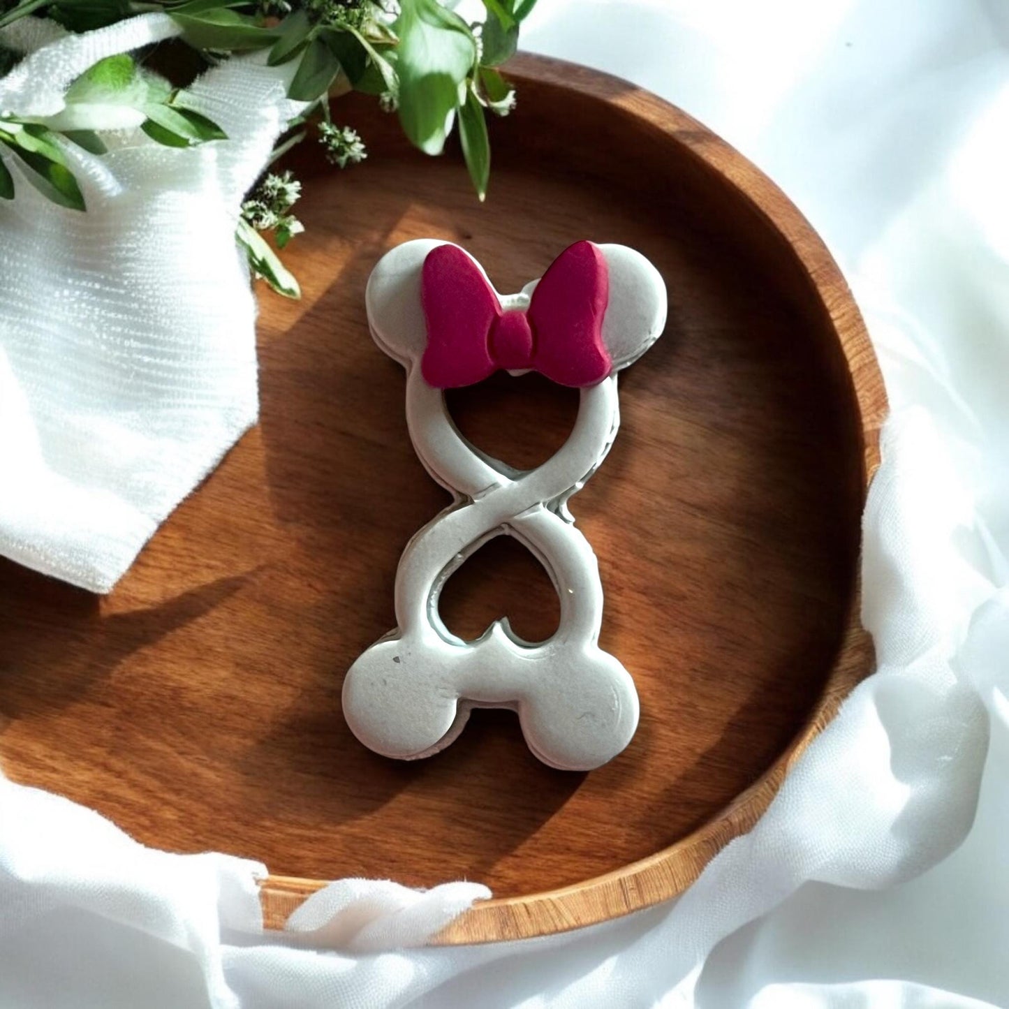 inished clay earrings shaped like mouse with bow