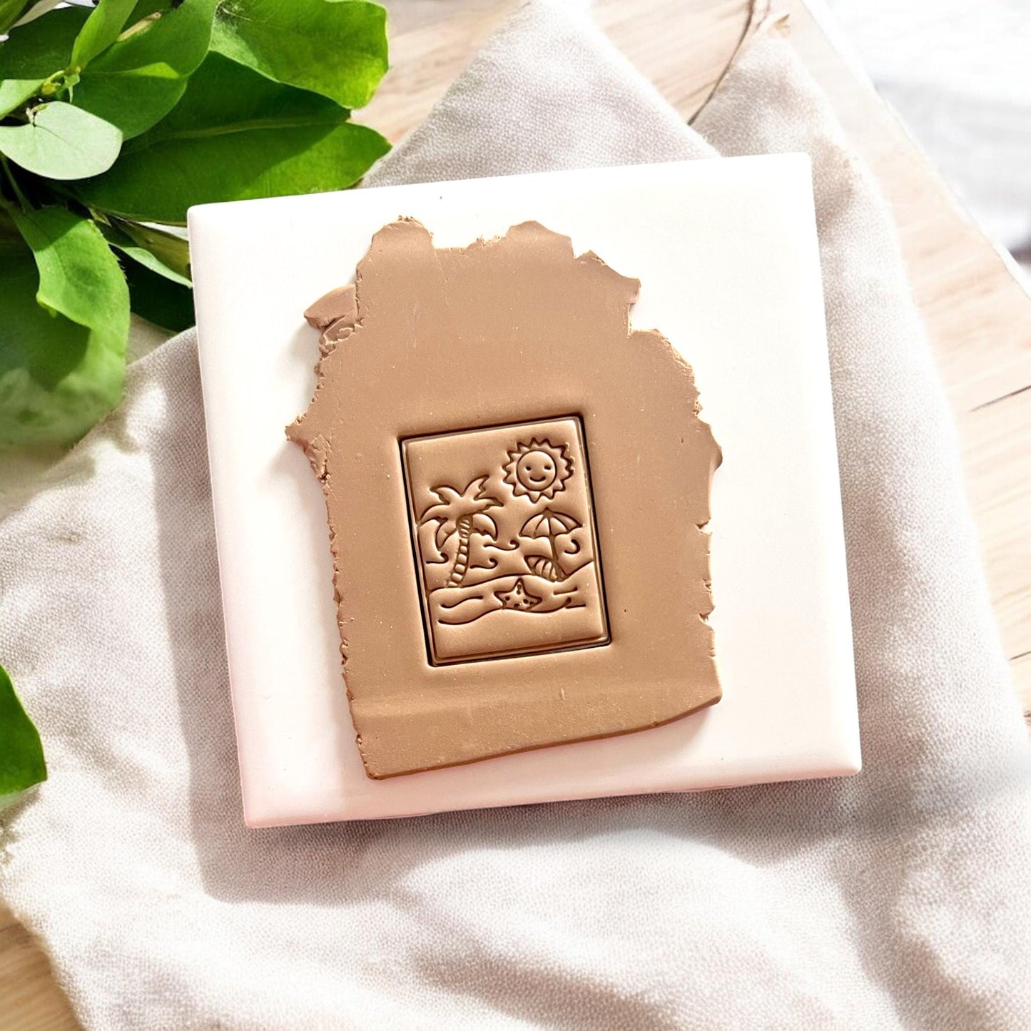 Beach clay slab stamped with rectangular sun and ocean cutter