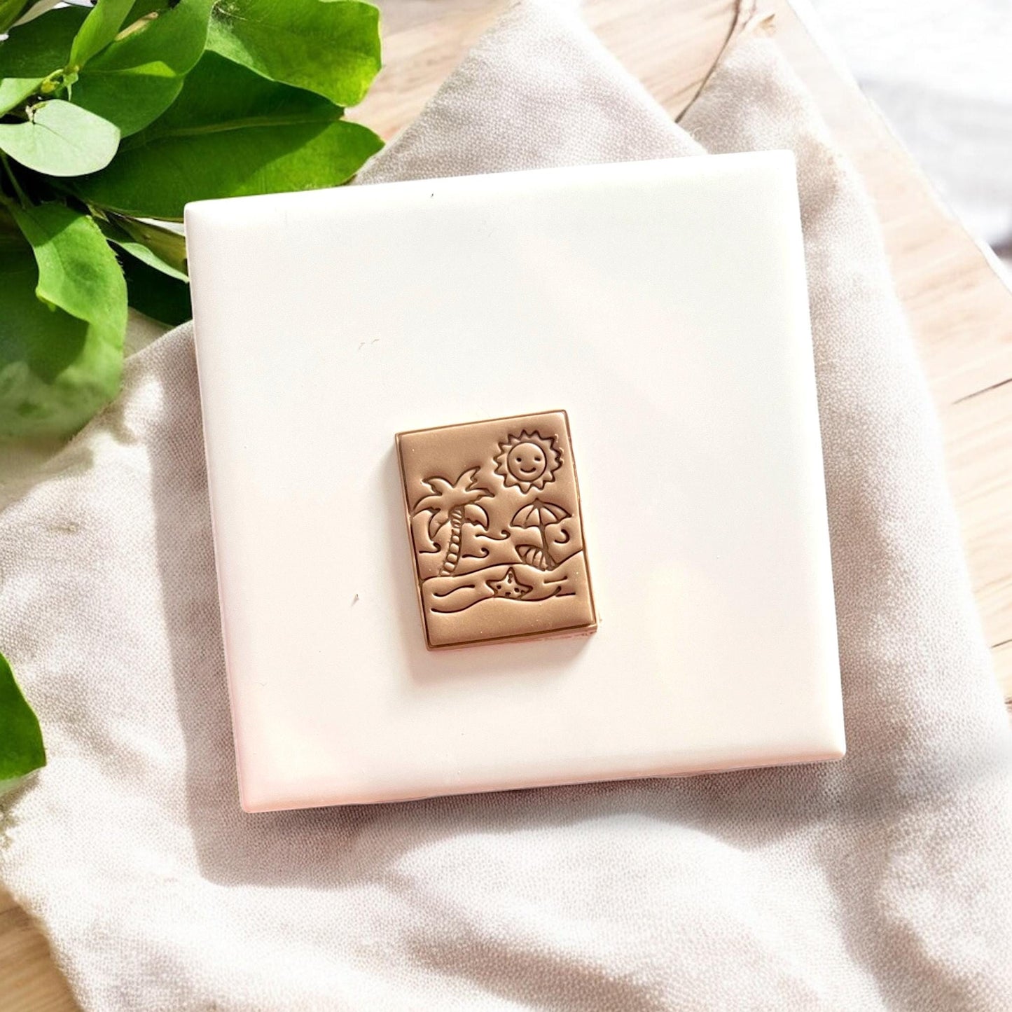 Cut beach clay piece with embossed palm tree and sun