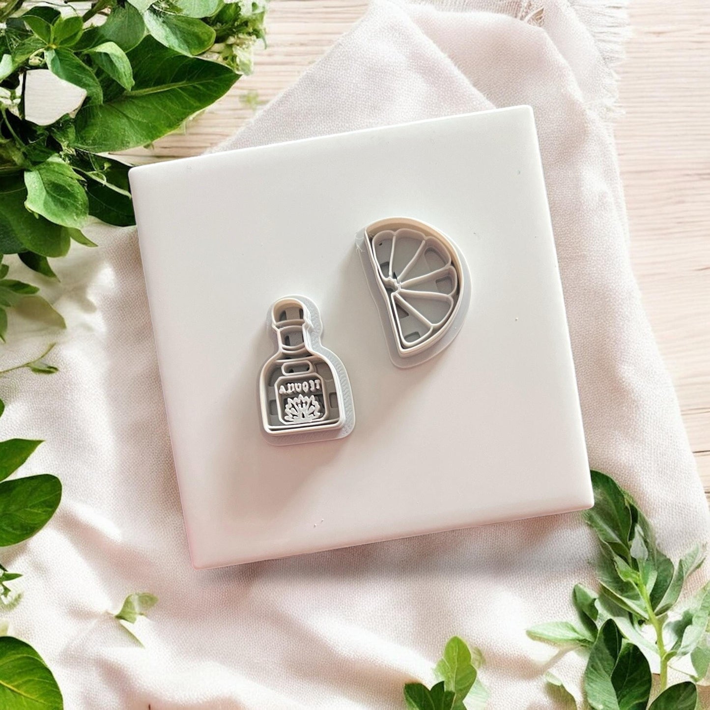 Close-up of tequila bottle and lime slice clay cutters