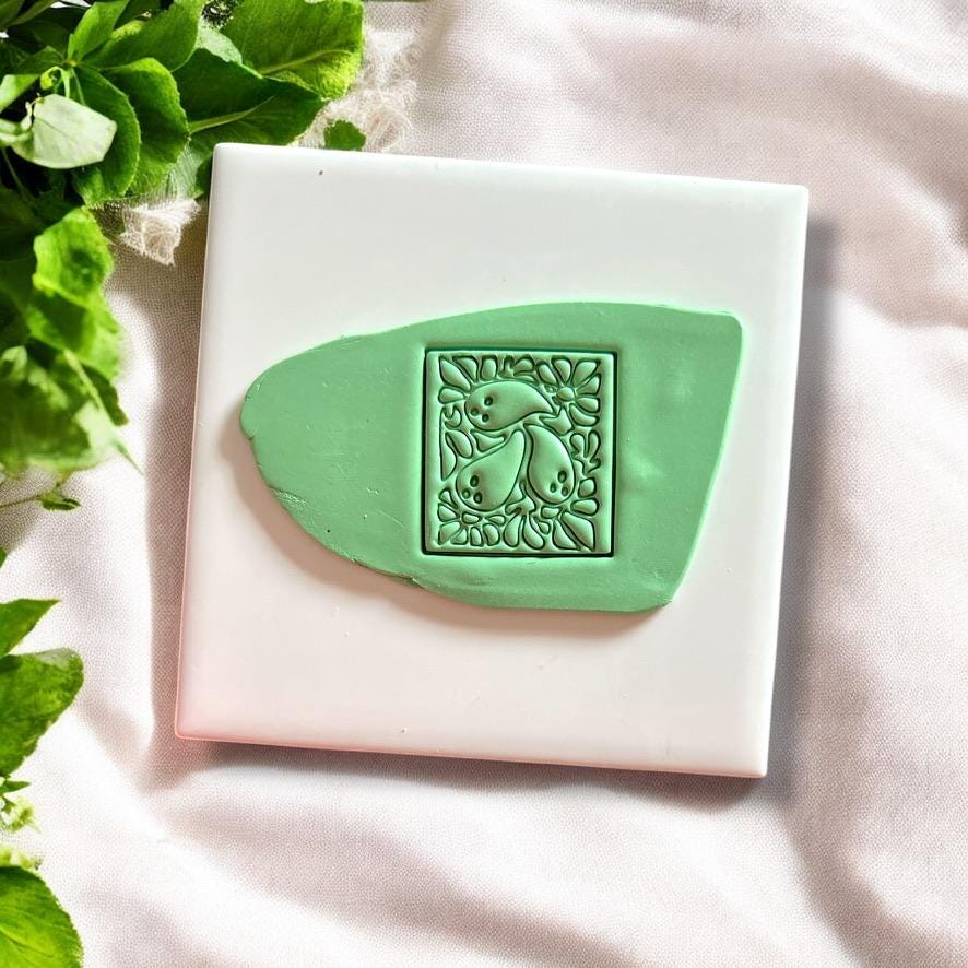 Ghost Matisse polymer clay cutter pressed into green slab showing spooky floral details clearly
