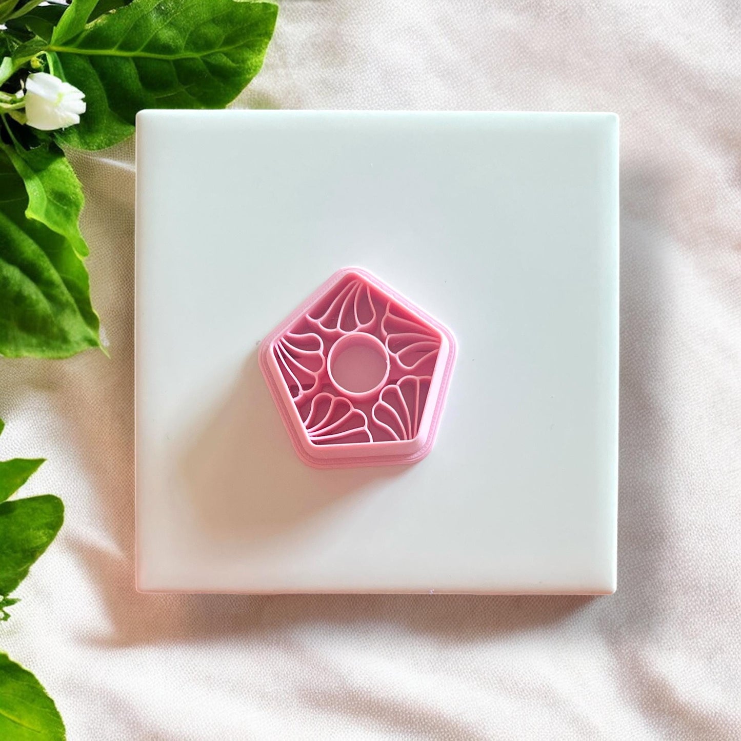 Set of floral motif polymer clay cutters displayed on a white surface, highlighting the intricate design.