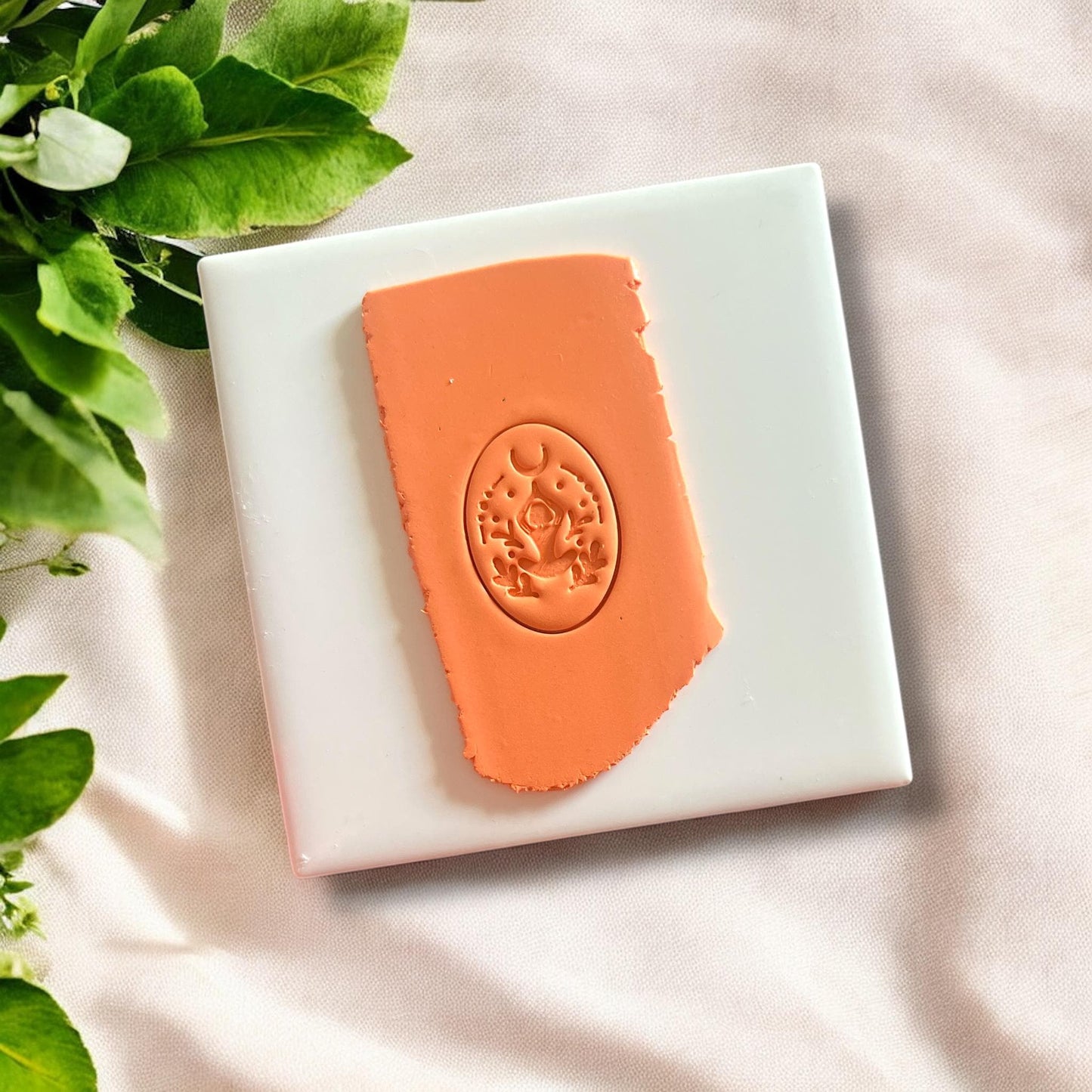 Front view of the yoga pose polymer clay cutter depicting a seated woman silhouette.