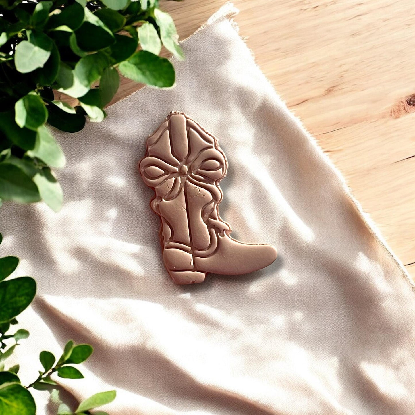 Close-up shot of the cowboy boot polymer clay cutter emphasizing the intricate bow design.
