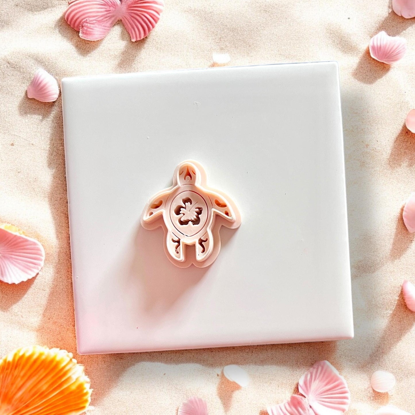 Clay cutter placed on top of finished sea turtle with floral pattern