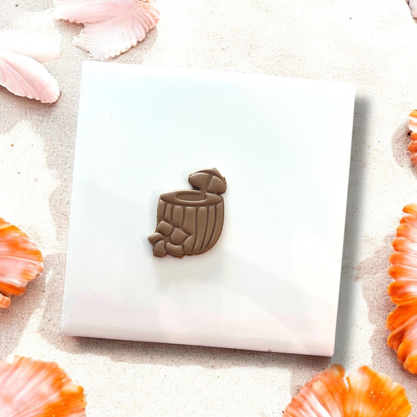 Finished clay piece of coconut drink with flower and straw