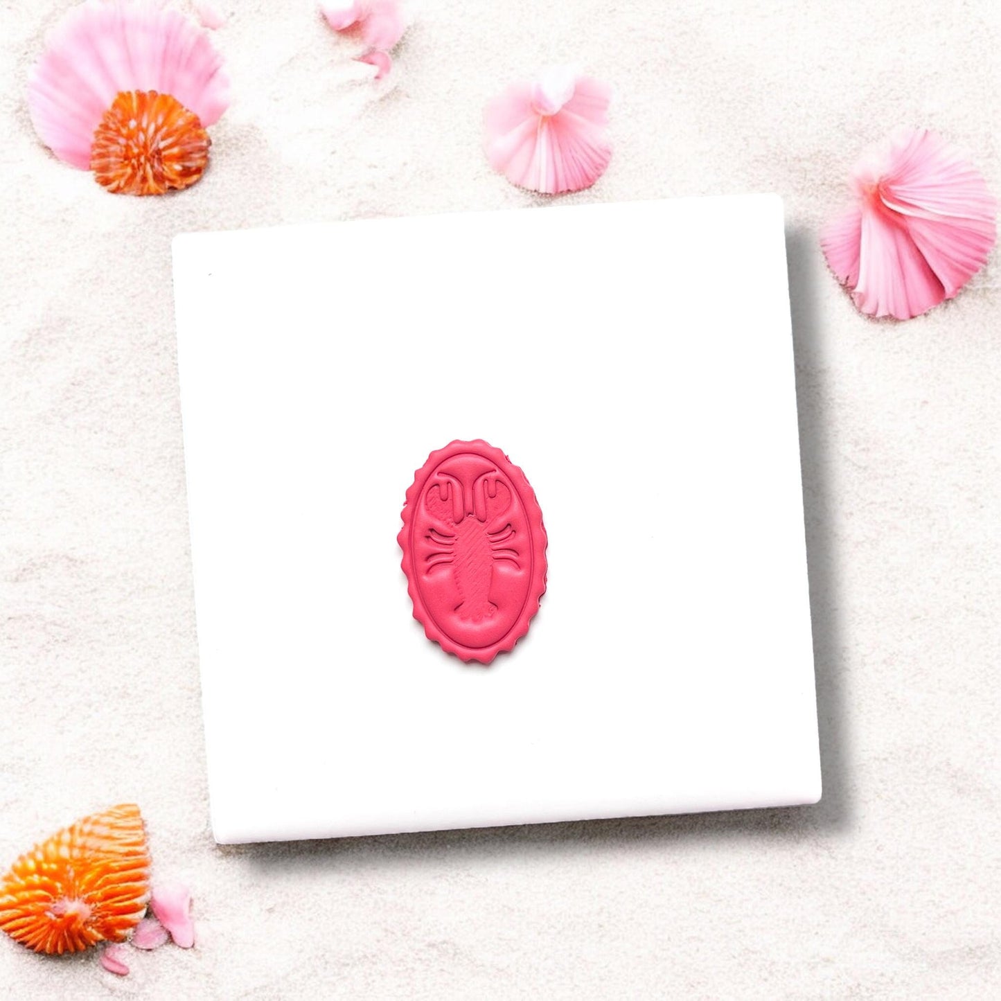 Completed oval lobster design in pink polymer clay