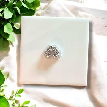 Gray crab cutter on white ceramic tile