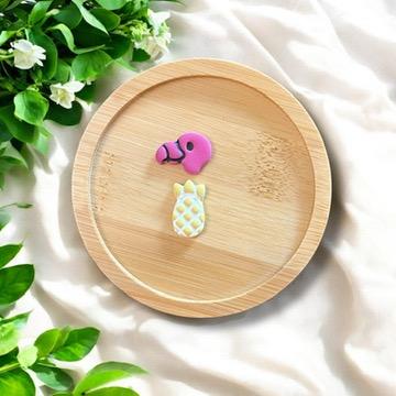 Flamingo and pineapple polymer clay earrings on bamboo dish