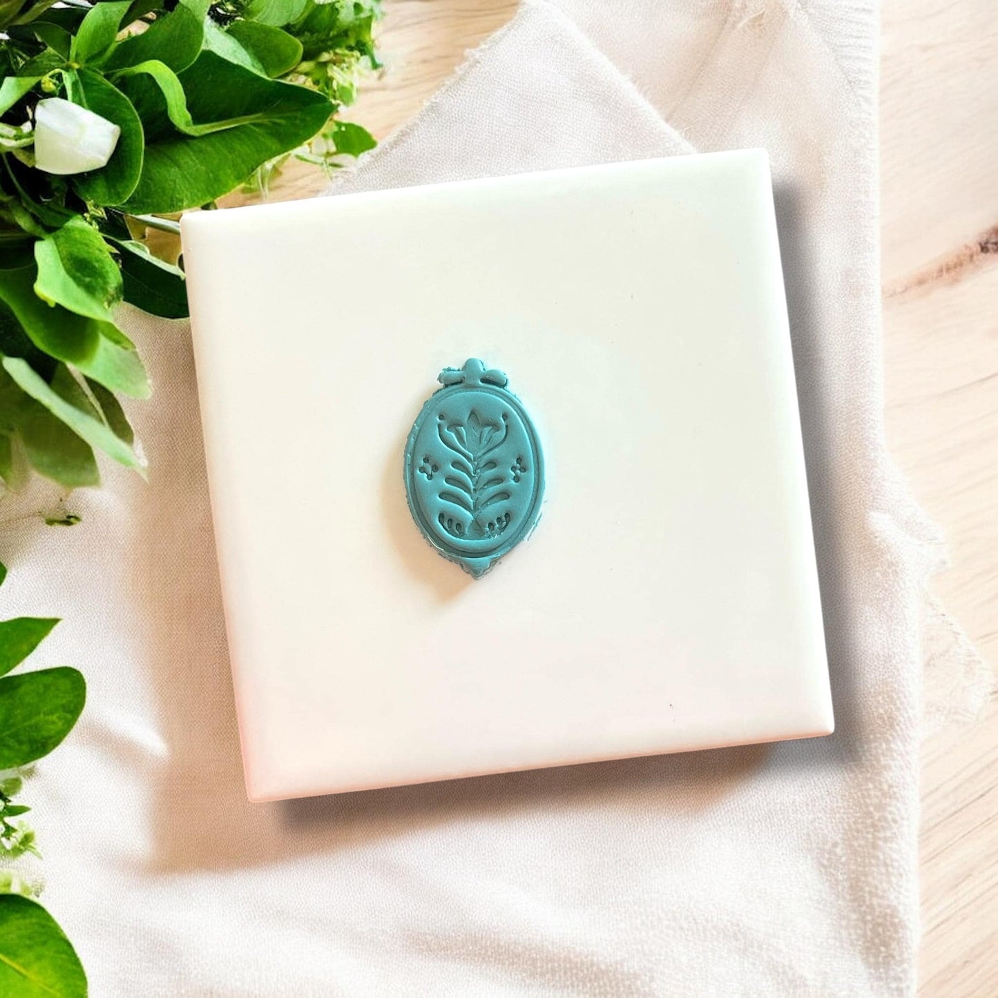 Scandinavian-style clay charm on white tile