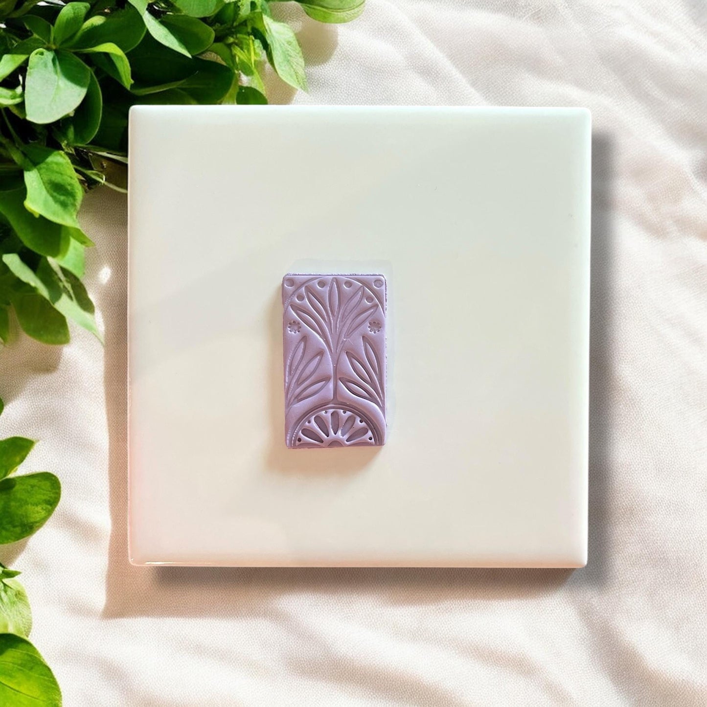 polymer clay piece with carved rectangle floral pattern