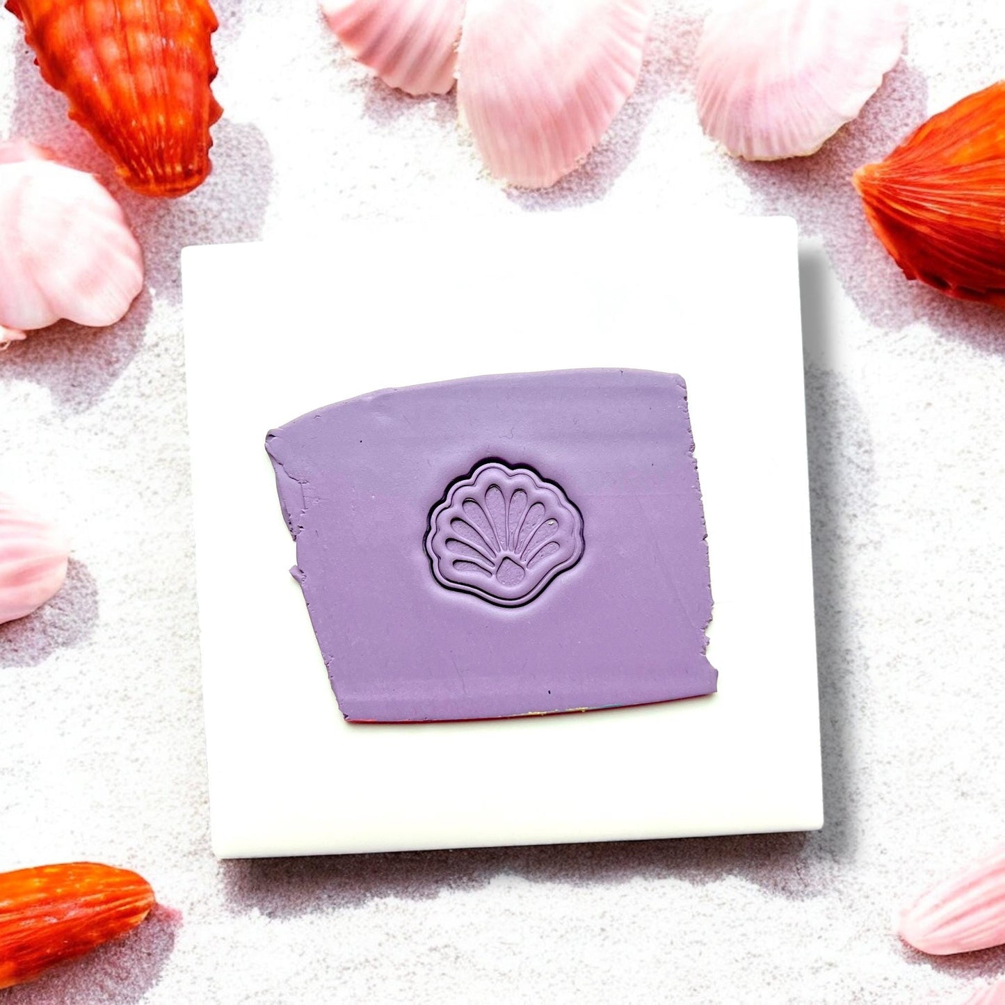 Purple clay with shell design pressed in