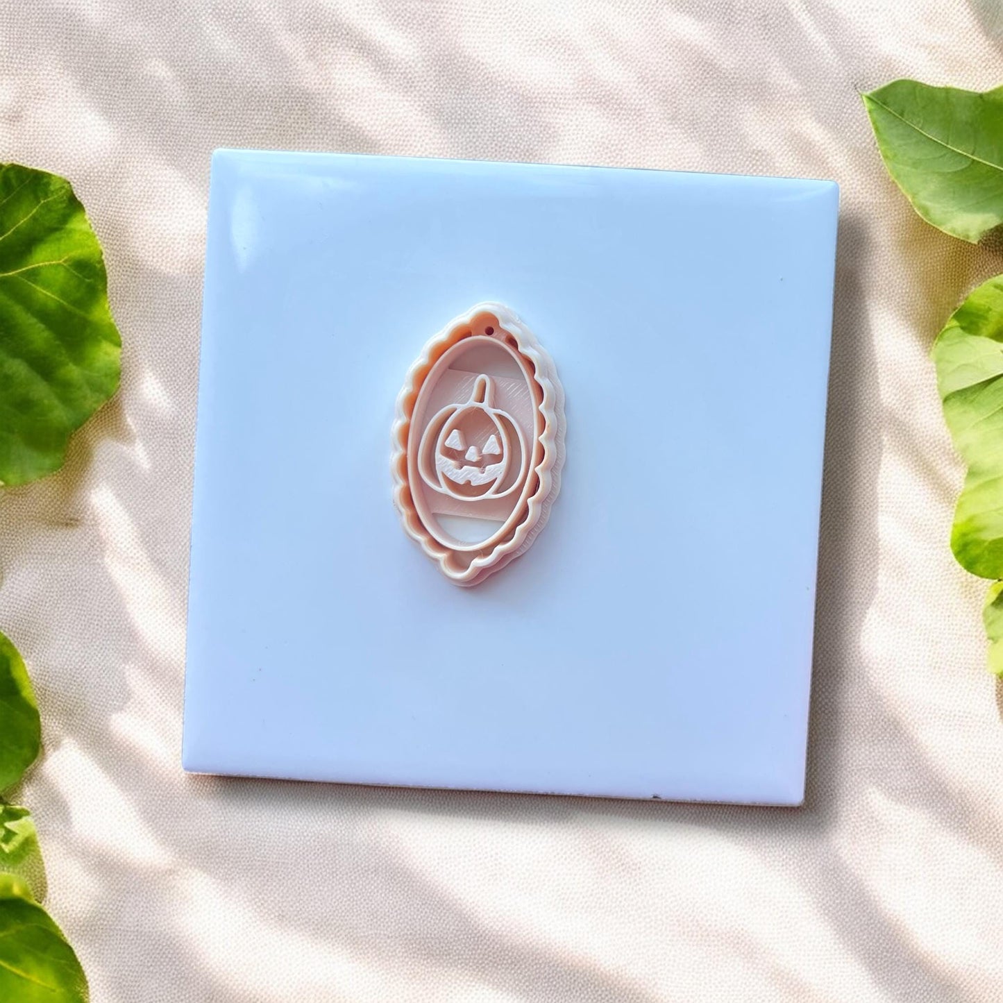 white oval cameo cutter with jack-o'-lantern design