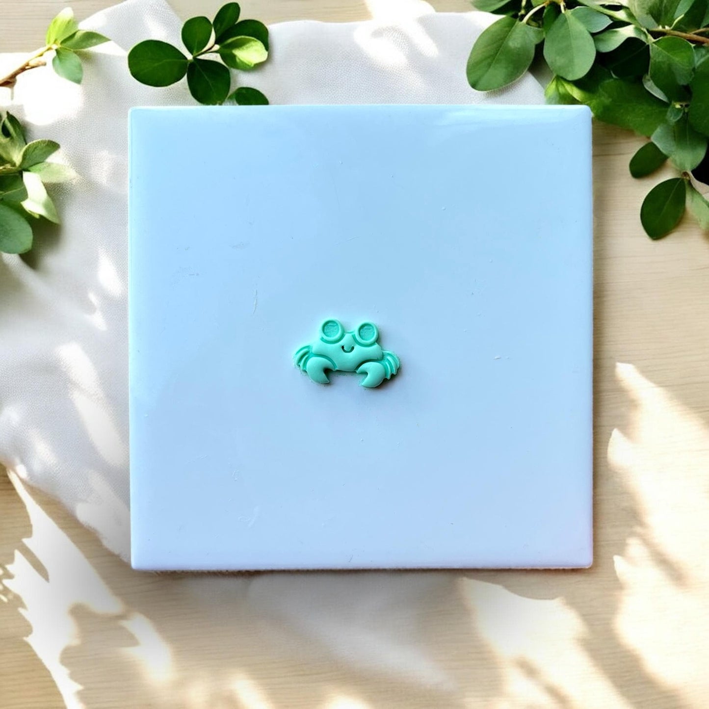 Finished small crab shape with big eyes on white tile
