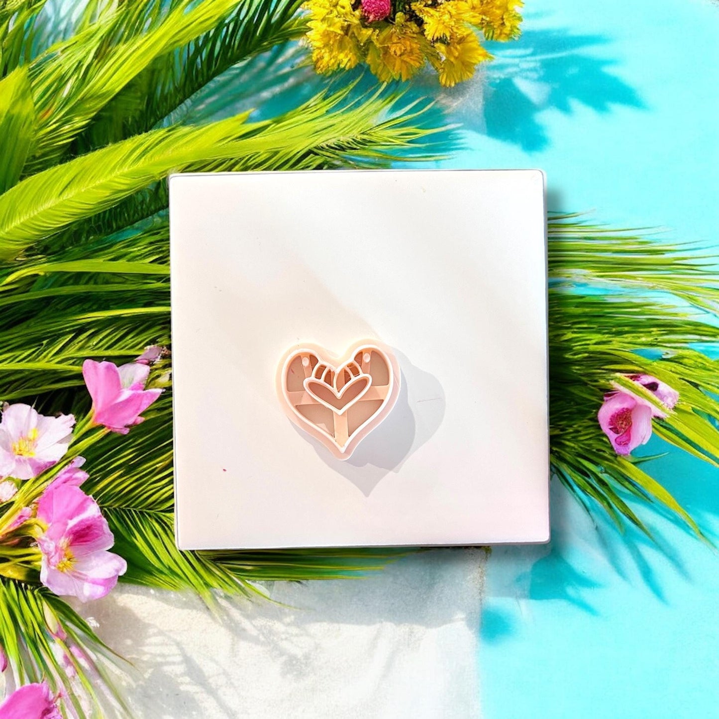 Heart-shaped flamingo bird clay cutter styled with palm leaves