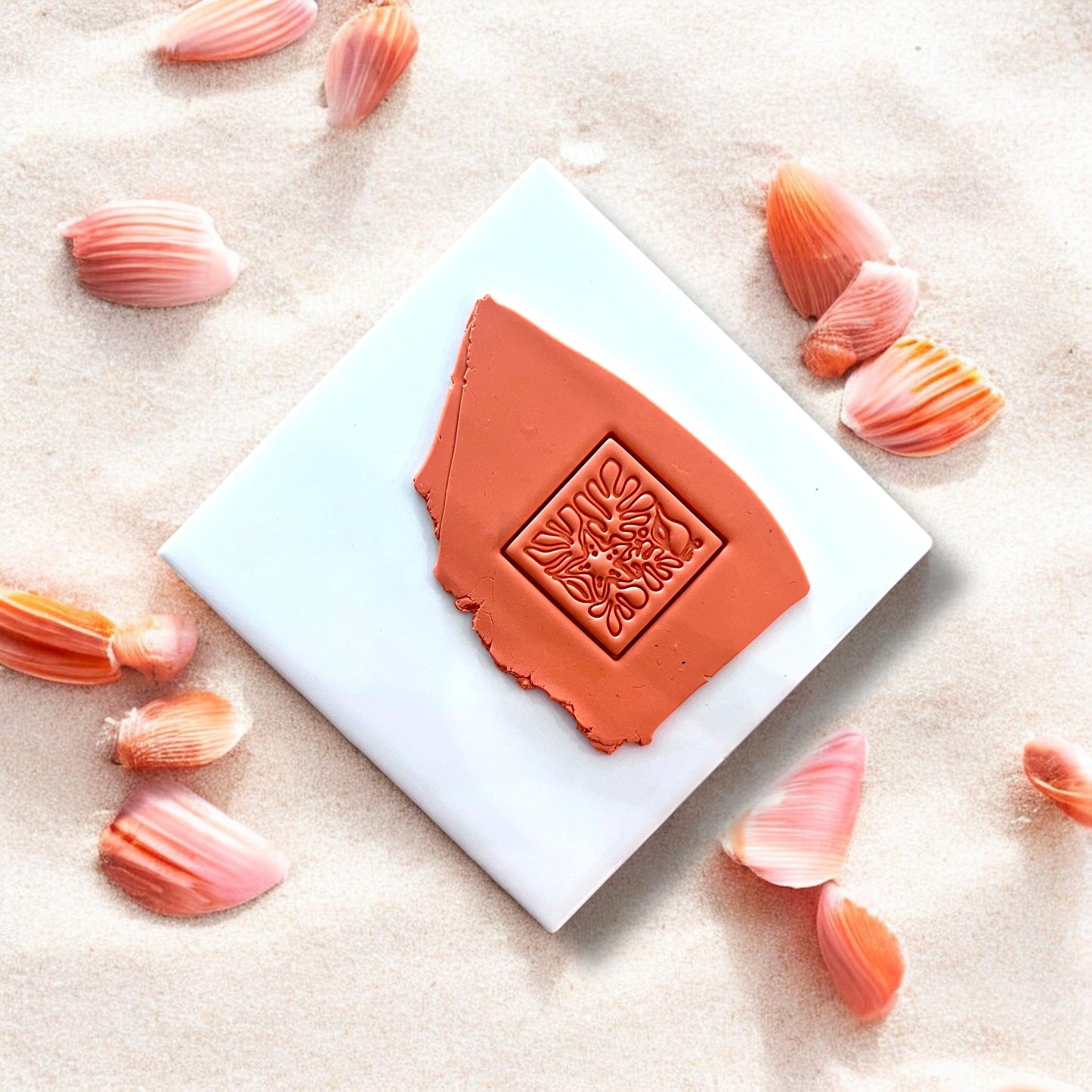 Clay slab with square beach motif impression in orange clay