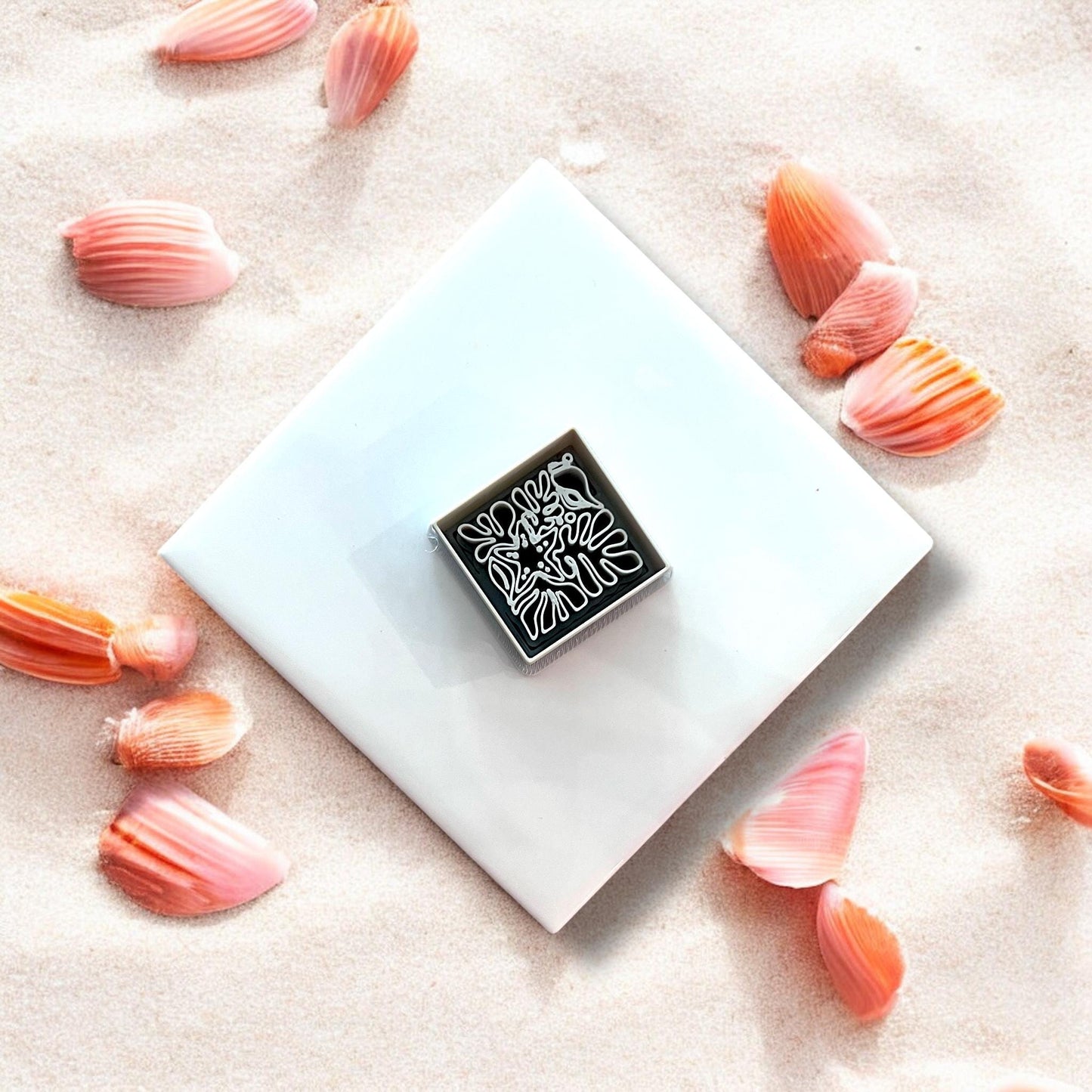 Overhead of detailed beach motif cutter on white tile