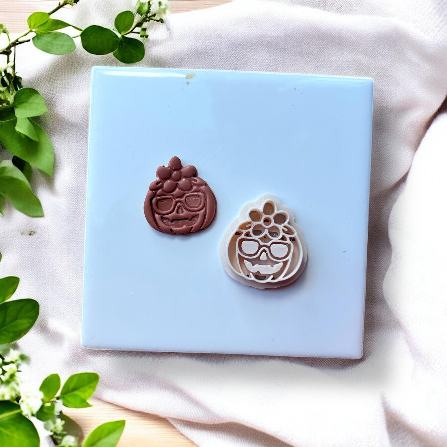 clay pumpkin next to polymer clay cutter