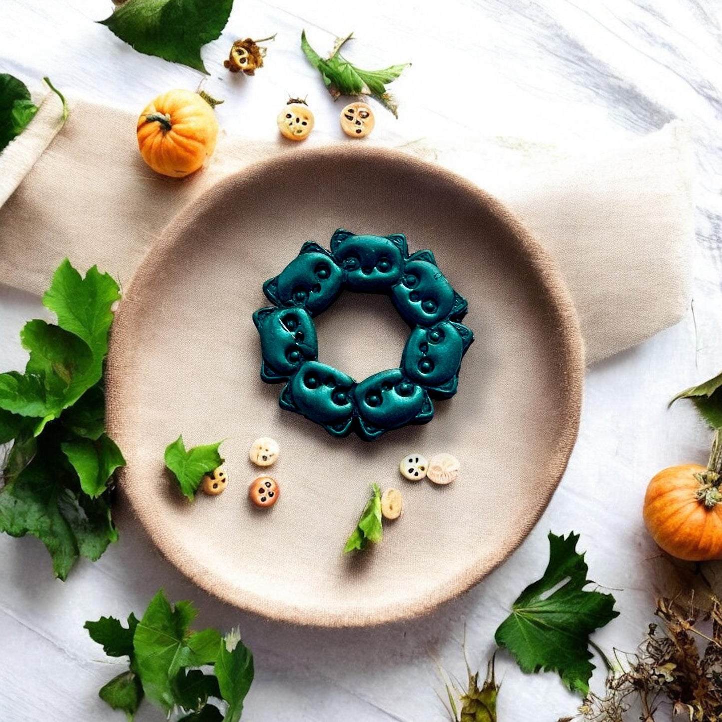 dark clay wreath with spooky cat faces