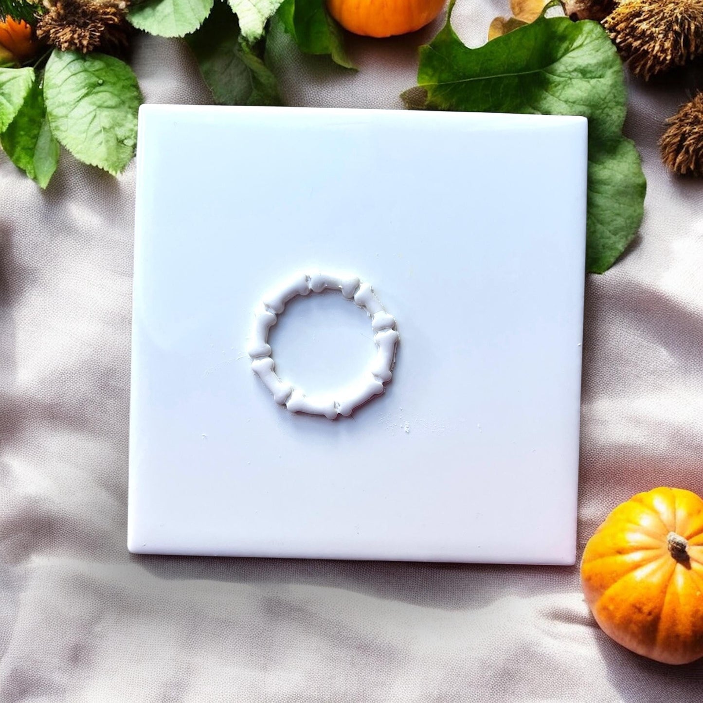 Cut bone wreath shape in white polymer clay