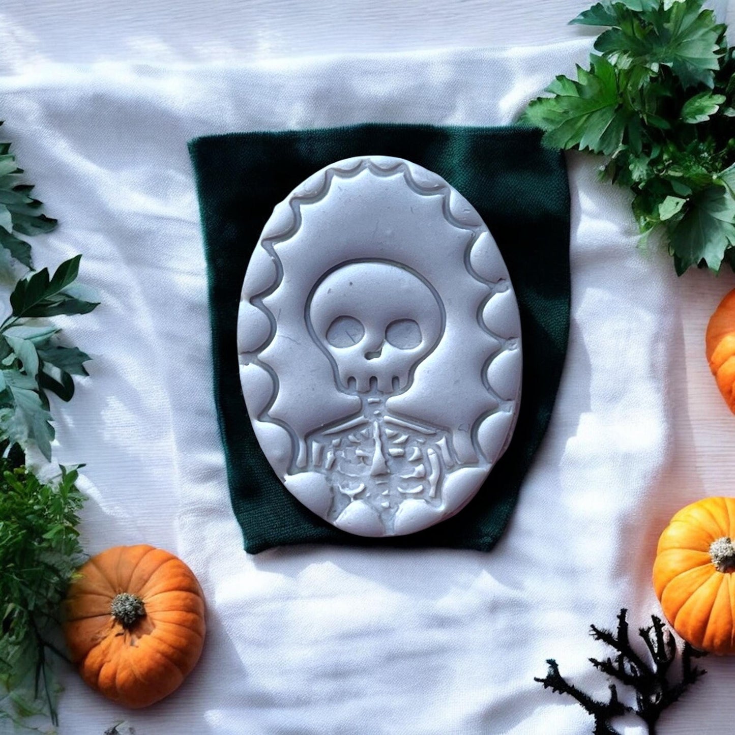 detailed clay skeleton cameo on fabric