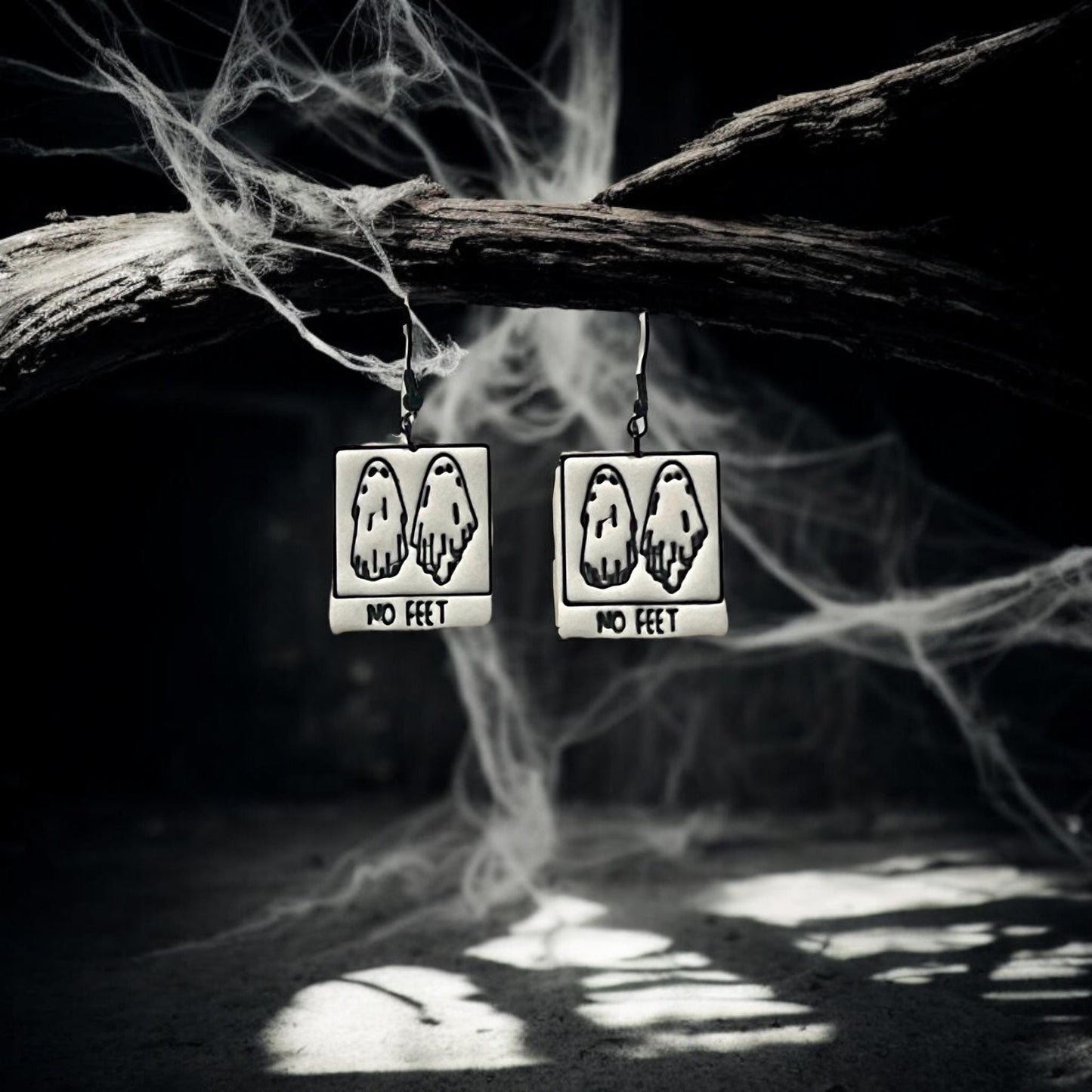 Finished No Feet ghost earrings hanging from spooky branch