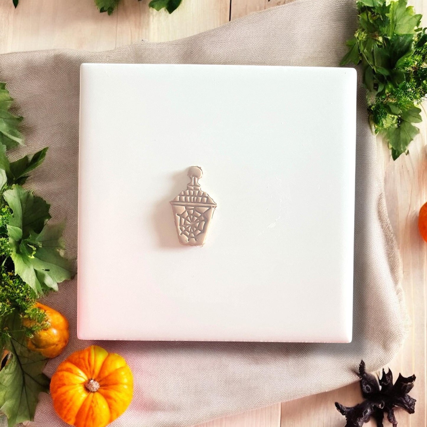 Lantern polymer clay shape on white tile