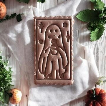 Ghost cameo stamp used on a slab of polymer clay for earring making