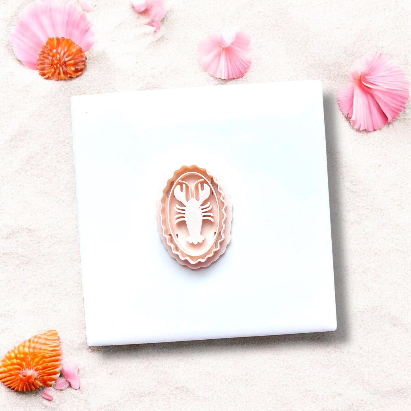 Lobster cameo clay cutter alone on white tile