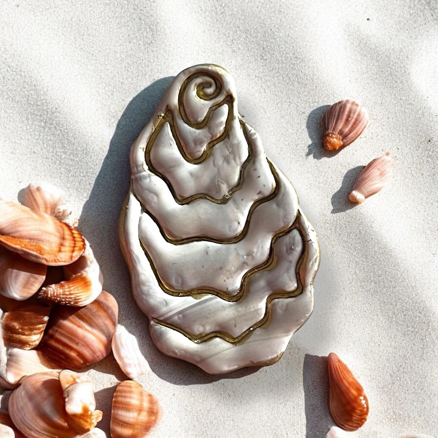 Molded oyster clay piece with metallic accents