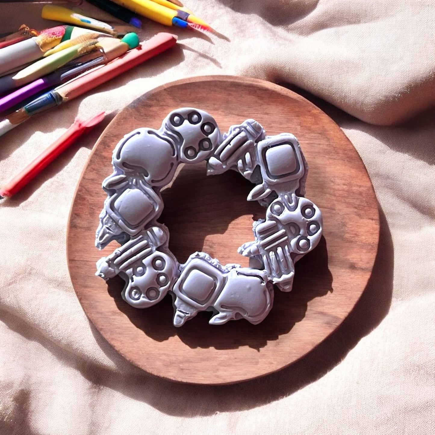 Zoomed in clay cutter with pencils, apples, and rulers
