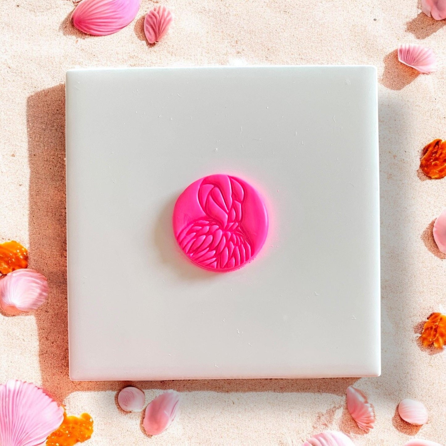 Flamingo head stamp cut from pink clay, centered on tile