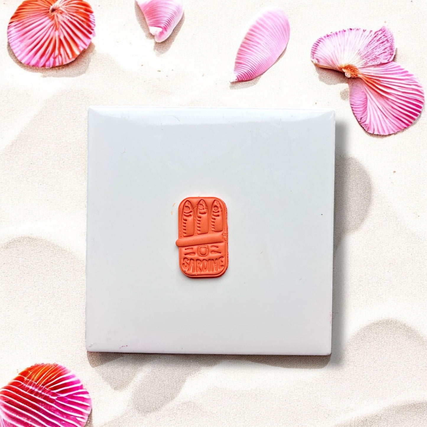 Finished sardines in a can clay piece on white tile