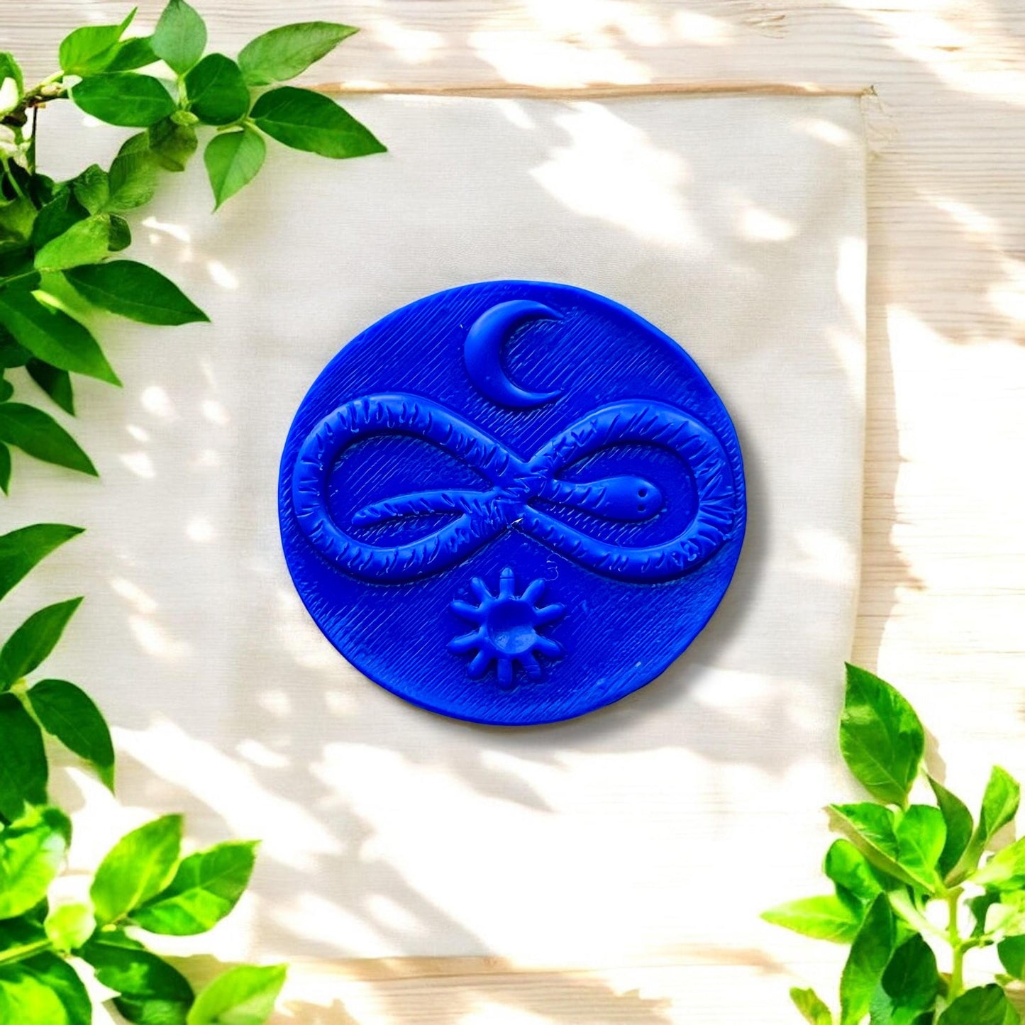 finished pendant with sun moon and snake stamped design