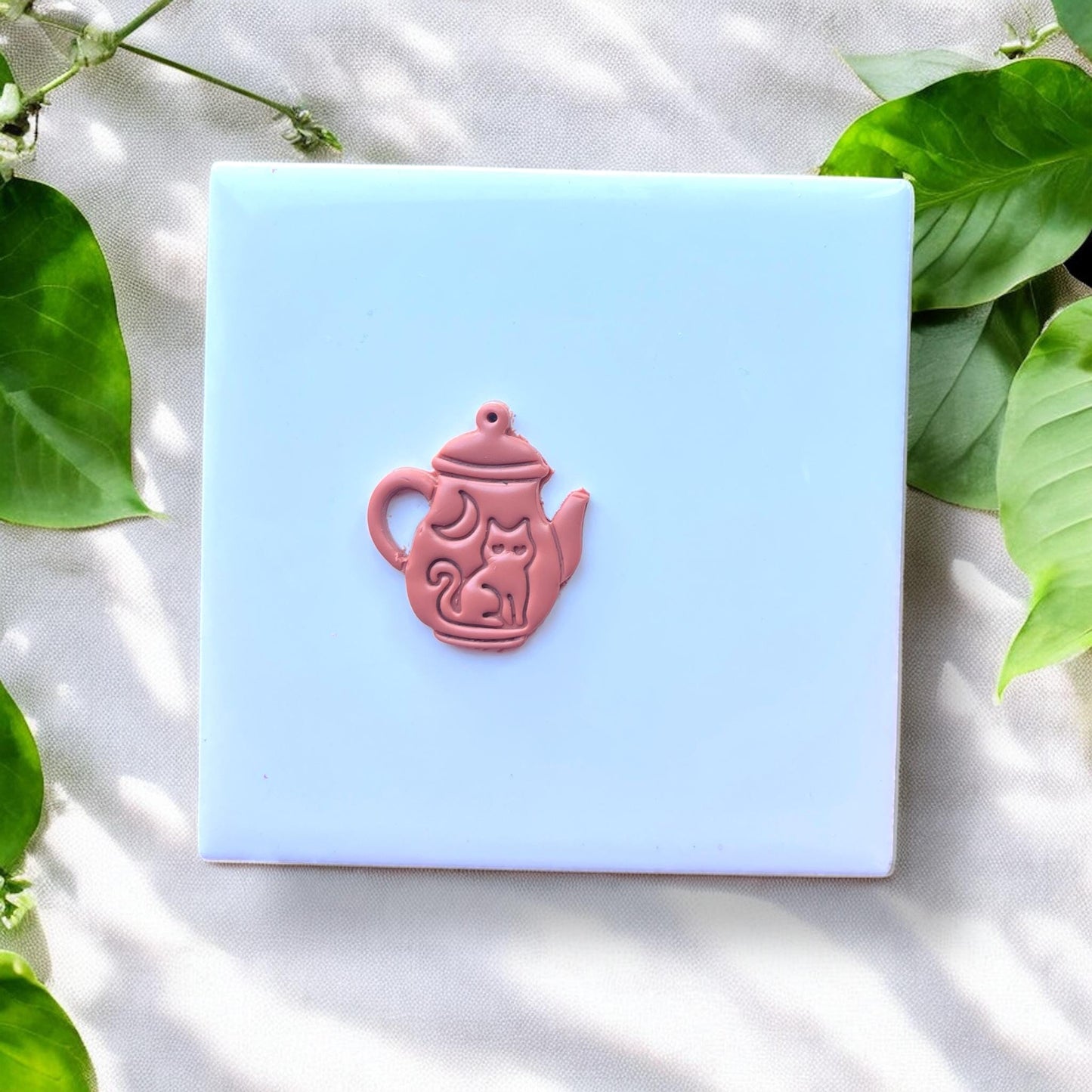 finished teapot charm with cat and moon design