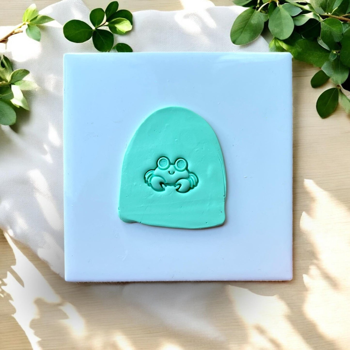 Debossed crab impression in mint green clay