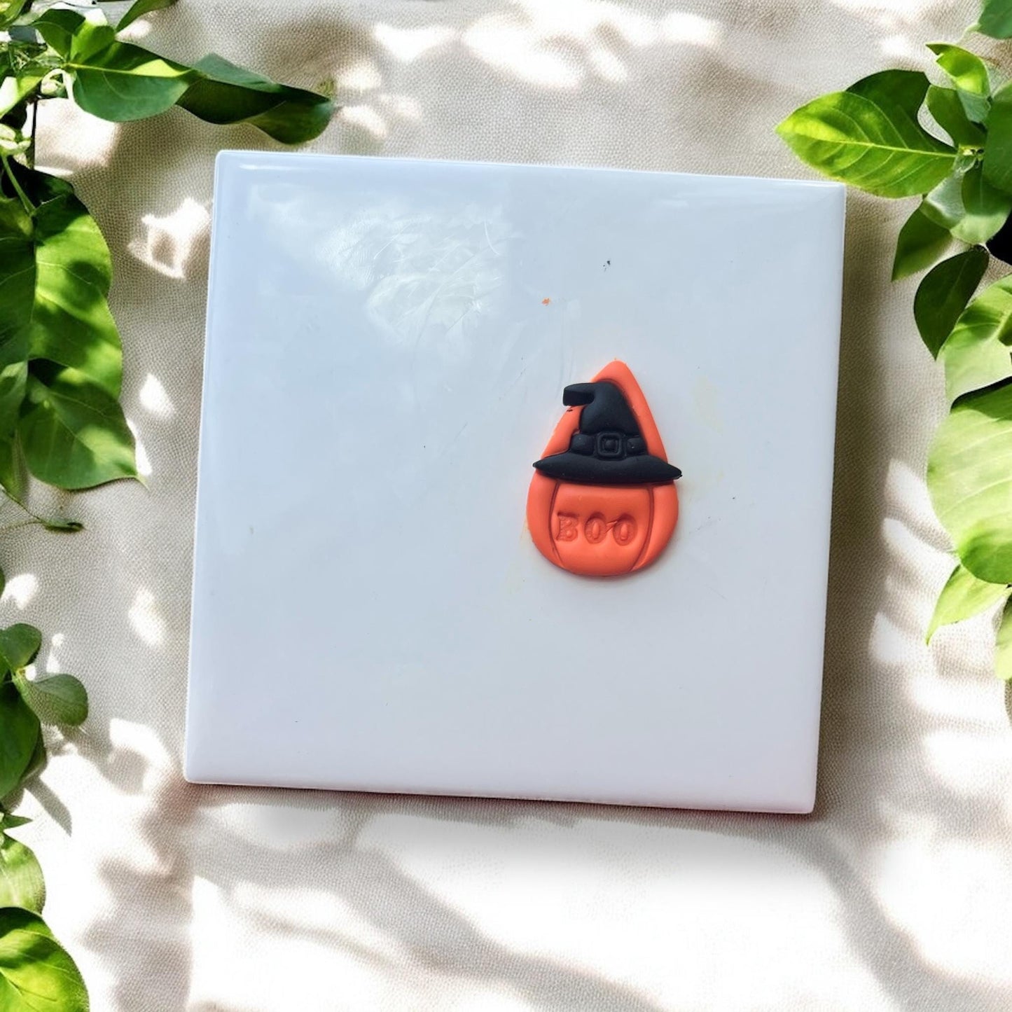 Finished pumpkin teardrop clay piece with witch hat