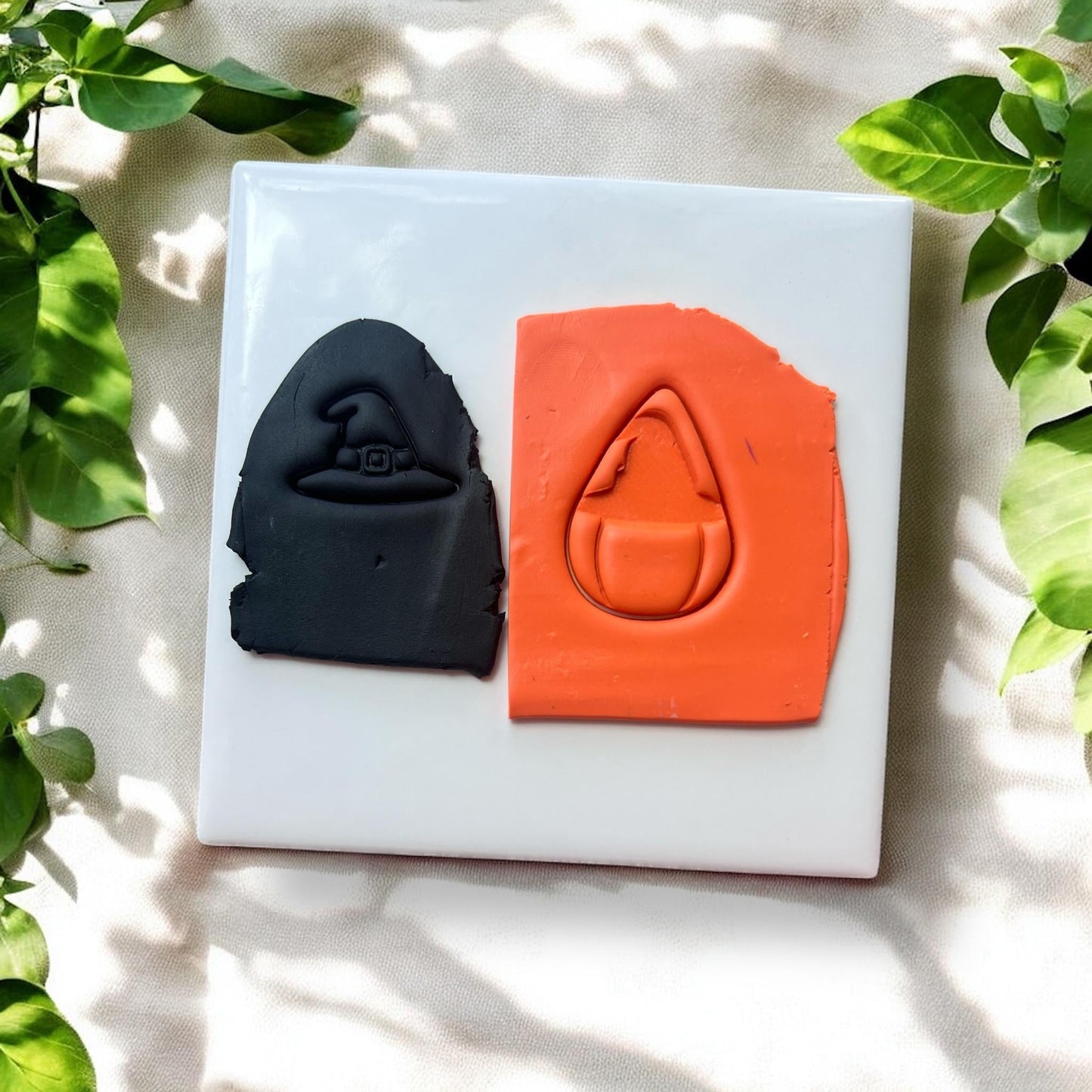 Pumpkin and witch hat impressions in clay