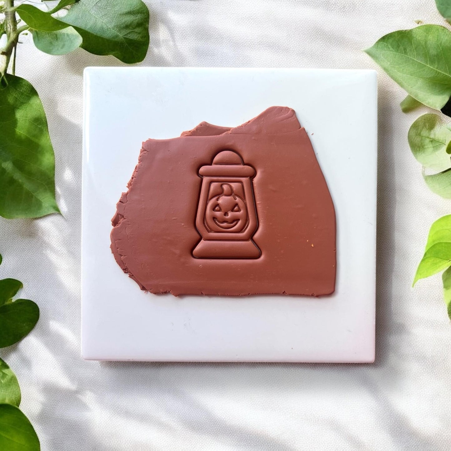 Pumpkin lantern clay design imprinted in brown clay
