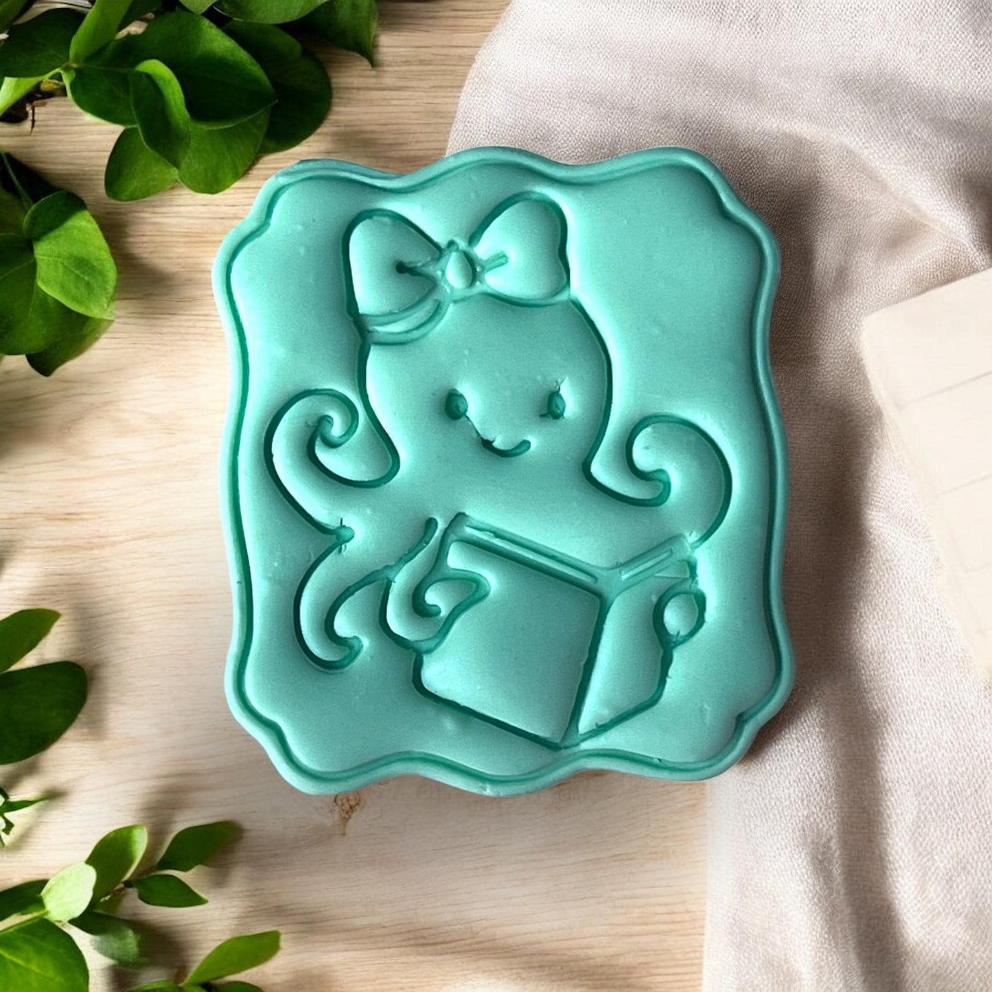 Close-up of octopus clay slab with embossed book design